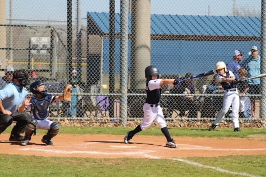 player swings at a ball pitch during a 10U baseball game