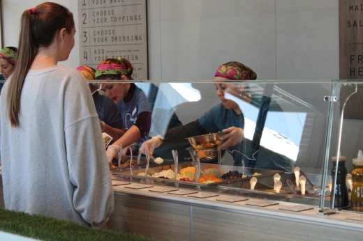 A person in line at Salata orders their food.