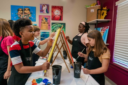 Children painting canvases