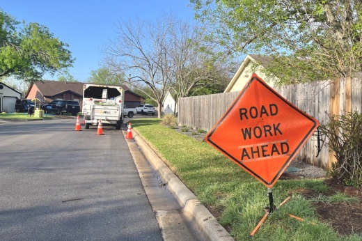 An orange road work sign