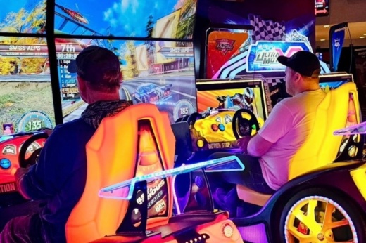 two people placing a racing game
