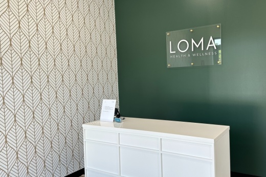 clinic lobby with a white desk and green and white walls