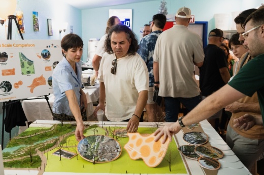 People looking at park design blueprints