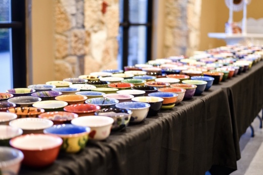 A table full of hand-painted bowls at a fundraising event