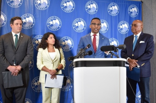 A press conference with Harris County officials standing at a podium