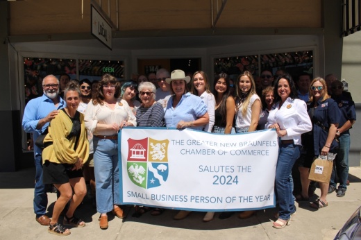 Kat Balmos, center, holding banner for award