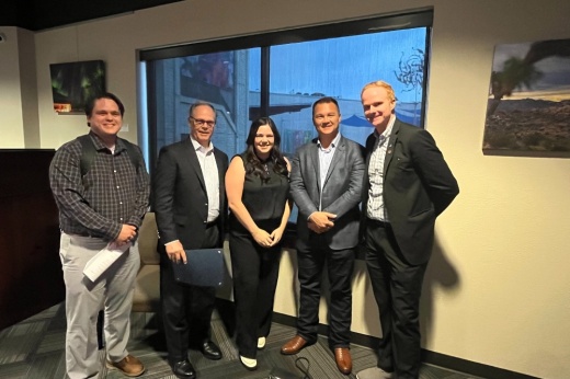 Assistant City Manager Brooks Bennett (right) stands with Dell Inc. representatives and Chamber President Jordan Robinson (center) as City Council approved an extension to an economic development agreement with the tech company.  (Haley McLeod/Community Impact)