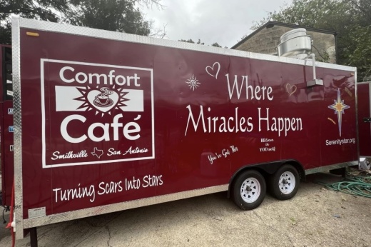 The maroon food trailer is shown with Comfort Cafe's logo .