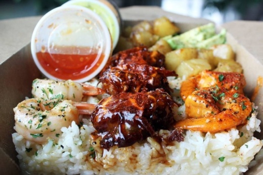 Shrimp prepared in a variety of sauces served on rice with dipping sauces on the side.