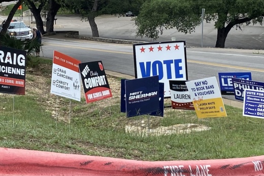 A group of voting signs