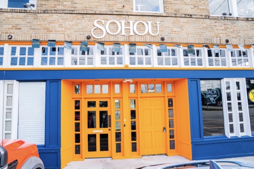 brick building exterior with orange doorway