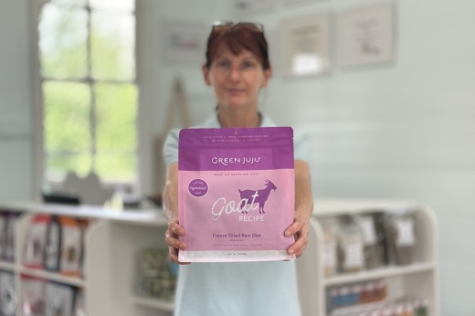 The owner holds a bag of dog food