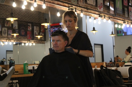 A person gets a haircut at Revolution Barbershop.
