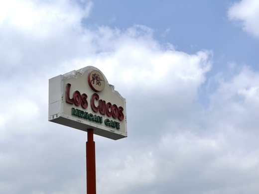 Image shows signage of Los Cucos Mexican Cafe.
