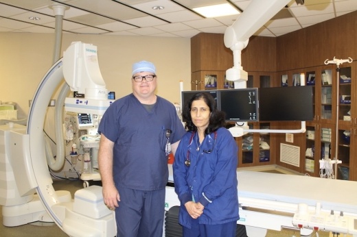 Picture of two people in a hospital lab room.
