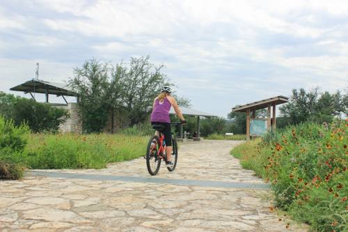 Robin Hegemier regularly bikes and hikes at Reimers Ranch Park in the Hill Country, adjacent to land newly acquired by the Travis County Parks Foundation's growing system. (Katy McAfee/Community Impact)