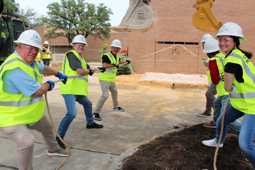 Members of Richardson City Council and city staff help with the demolition of City Hall