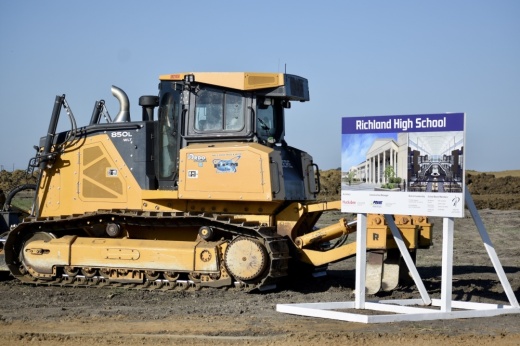 a construction vehicle next to a sign for Richland High School
