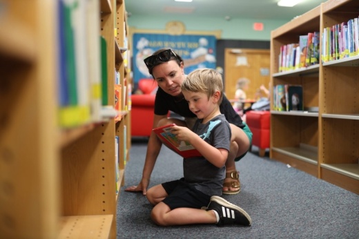 Child reading in library