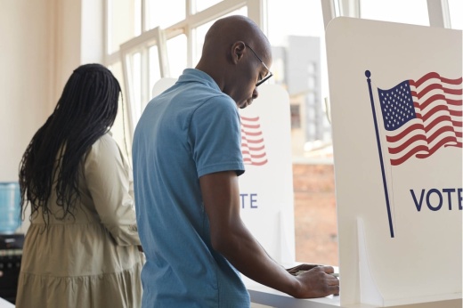 Two voters casting their ballot.