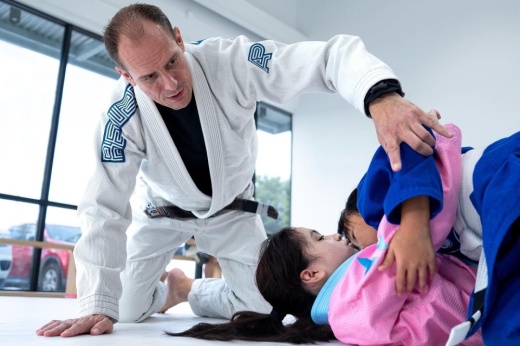 Teacher instructing two students doing martial arts