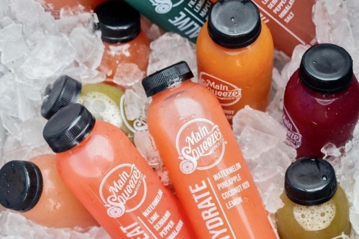 bucket of juice bottles on ice