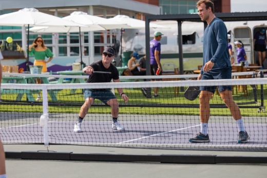 Two men are playing pickleball.