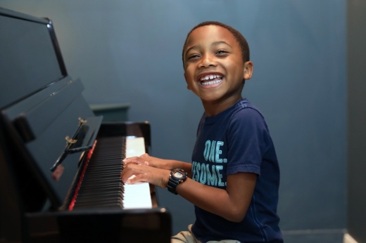 boy plays the piano