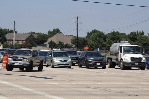 Picture of cars traveling at an intersection.