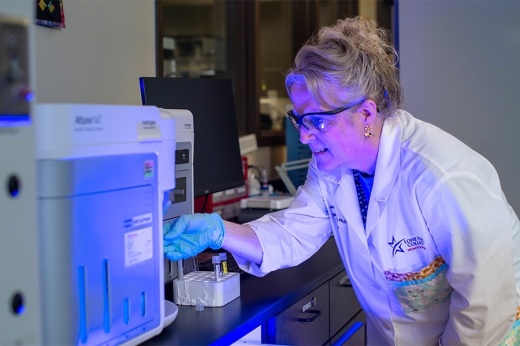 A woman works with lab equipment