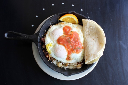 Eggs, hashbrowns, sausage and tortilla in a small skillet