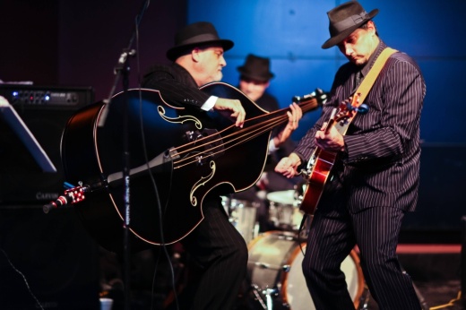 Males playing stringed instruments.