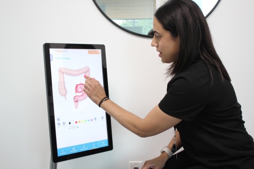 woman pointing at screen with picture of intestine