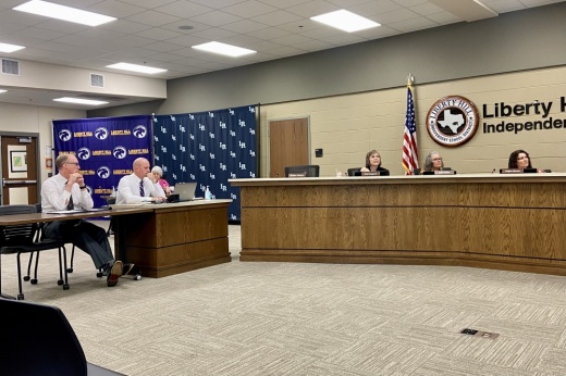 Two men present to the board of trustees