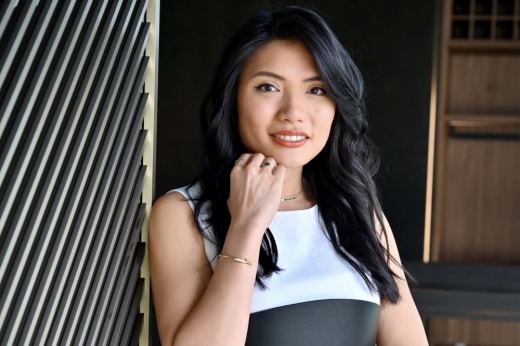 a headshot of a woman leaning against a wall