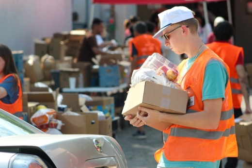 Hays County Food Bank volunteer loading trunk with food