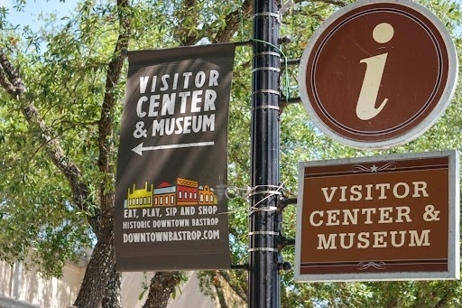 An image of a street banner advertising the Bastrop County Museum and Visitor Center.