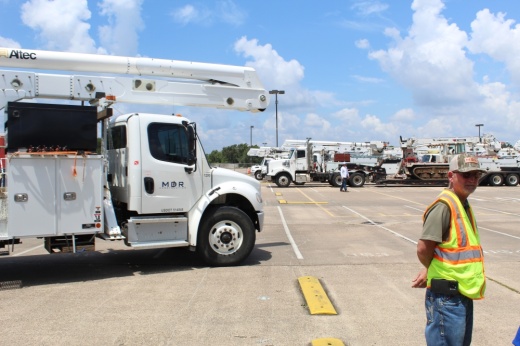 Power repair trucks with man in reflective vest
