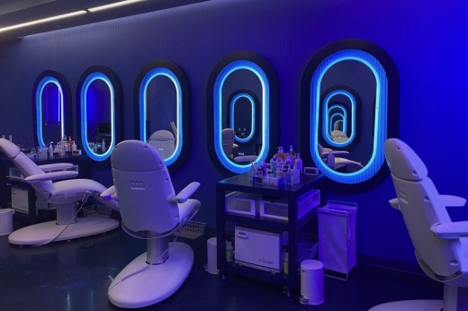 the interior of a salon with several salon chairs facing mirrors