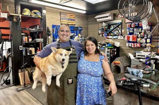 Image shows the owners of Trailhead Mountain Bike Shop and their dog.