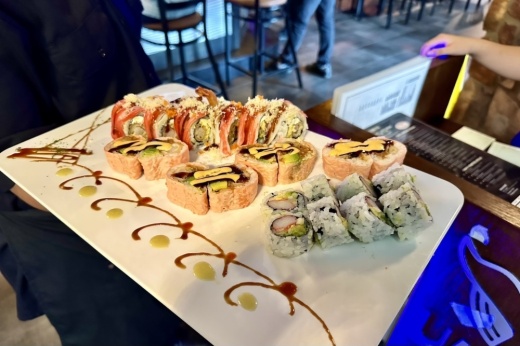 Photo shows an array of sushi rolls.