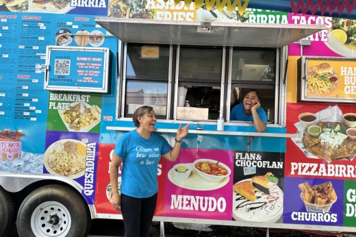 The owner and an employee pose for a photo in front of the truck.