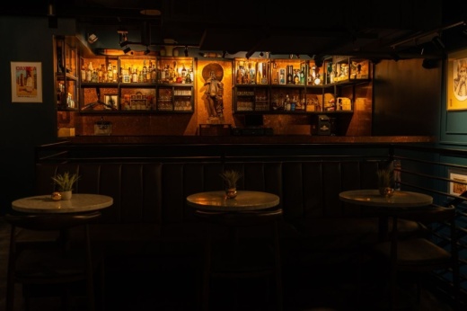 the interior of a darkly lit room with a bar