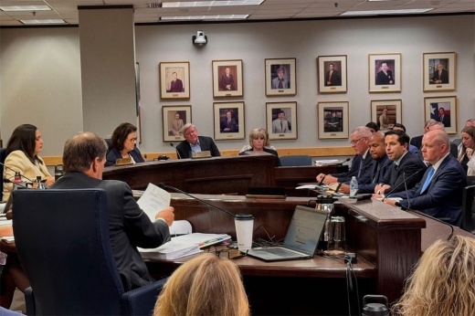 A photo of the Public Utility Commission of Texas commissioners next to CenterPoint officials.