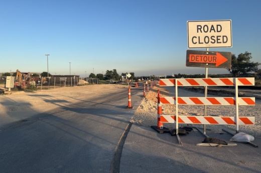 A sign says "road closed, detour"