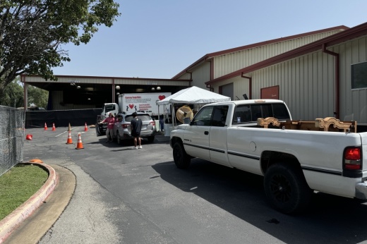 A white truck pulls up to a donations drop off site.