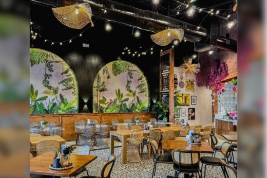 a restaurant interior with tables, chairs and a wall with decorative painting