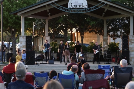 Picture of a band playing in a town plaza.