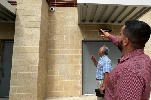 Paul Duran, North East ISD’s senior director of security and safety, and Andrew Olivares, a safety and emergency specialist, check external doors and security cameras at Garner Middle School in November 2022. As part of ongoing efforts to improve district facility safety and security, NEISD recently created a specially trained emergency response team. (Courtesy North East ISD)