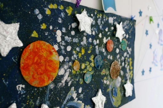 A school board is decorated in a space theme.